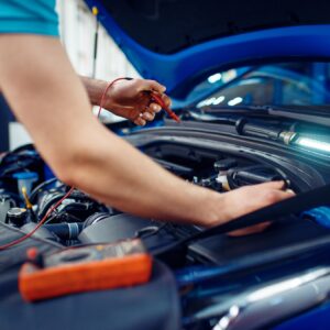 Auto electrician checks electrical circuits