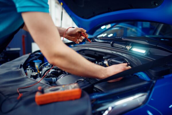 Auto electrician checks electrical circuits